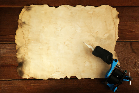 Machine for tattoo with old paper on table close upの写真素材