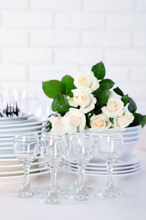 Clean plates, glasses and cutlery on white tableの写真素材