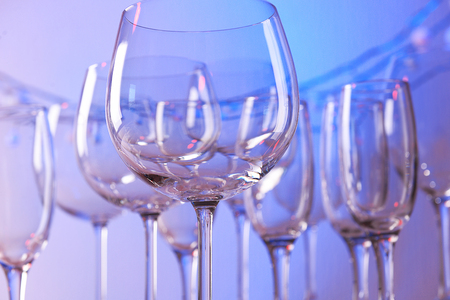 Empty wine glasses on color backgroundの写真素材