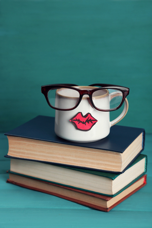 Vintage books and cup with lips on colorful backgroundの写真素材
