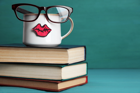 Vintage books and cup with lips on colorful backgroundの写真素材