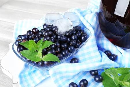 Glass saucer of fresh blackcurrant with ice cubes on napkin, closeupの写真素材