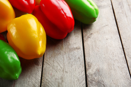 Colorful peppers on rustic wooden backgroundの写真素材