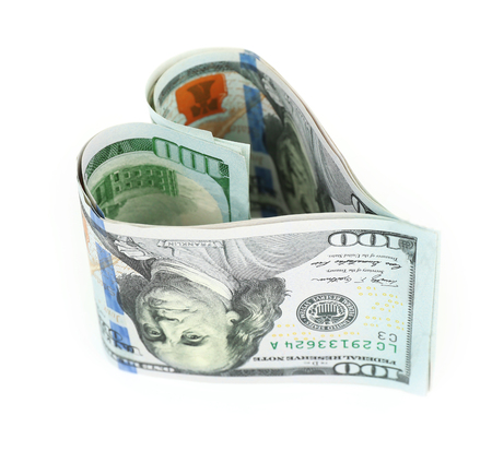 Money in form of heart isolated on whiteの写真素材