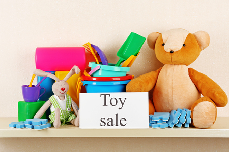 Toys for sale on shelf, on light wall backgroundの写真素材