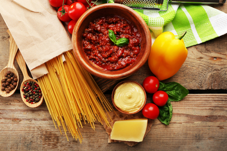 Pasta spaghetti with tomatoes, sauce bolognese, cheese and basil on rustic wooden  backgroundの写真素材