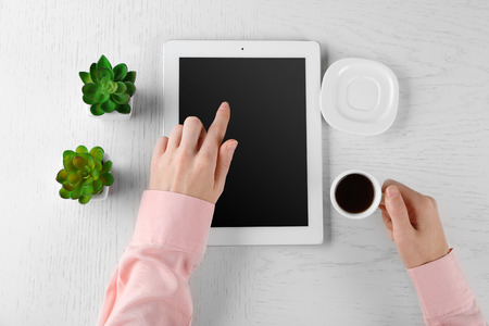 Hands working in the office with tablet on white tableの写真素材