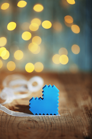 Heart on wooden table and blurred background with lightsの写真素材