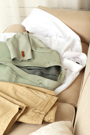 Male clothing on sofa in roomの写真素材