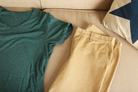 Male clothing on sofa in roomの写真素材