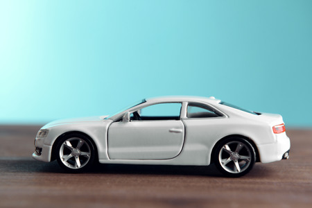 Small toy car on blue backgroundの写真素材