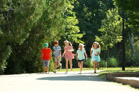 Happy active children running in parkの写真素材