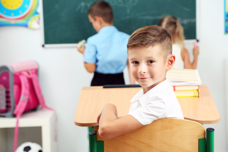 Portrait of happy pupil at lessonの写真素材