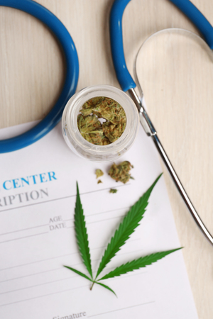 Medical prescription with dry cannabis on table close upの写真素材