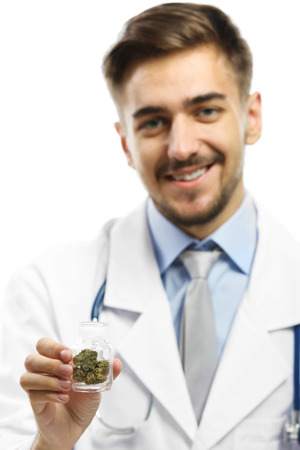 Doctor holding bottle with medical cannabis close upの写真素材