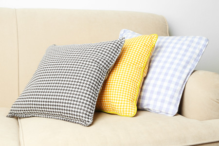 Colorful pillows on sofa, close-up