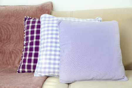 Colorful pillows on sofa, close-up