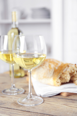 Still life of wine and bread on light backgroundの写真素材