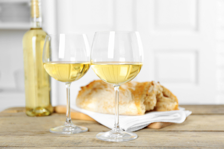 Still life of wine and bread on light backgroundの写真素材