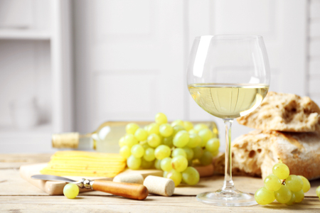 Still life of wine, grape, cheese and bread on light backgroundの写真素材