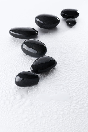 Wet spa stones isolated on whiteの写真素材