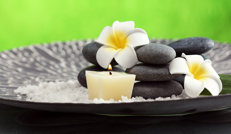 Still life with spa stones on green backgroundの写真素材