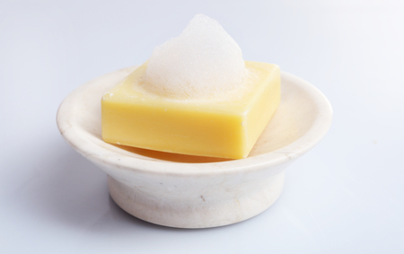Soap with foam isolated on whiteの写真素材