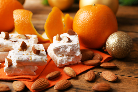 Sweet nougat with oranges and Christmas decoration on table close upの写真素材
