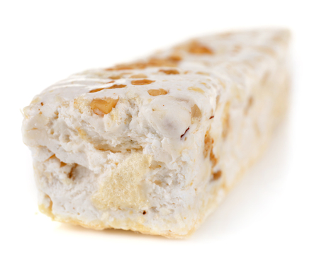 Sweet nougat with hazelnuts isolated on whiteの写真素材