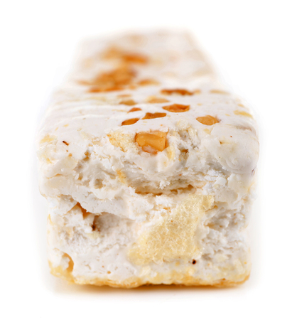 Sweet nougat with hazelnuts isolated on whiteの写真素材