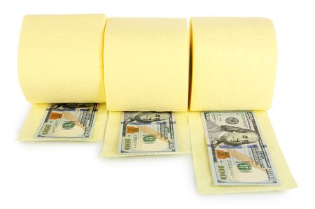 Rolls of light yellow toilet paper and dollar banknotes isolated on whiteの写真素材