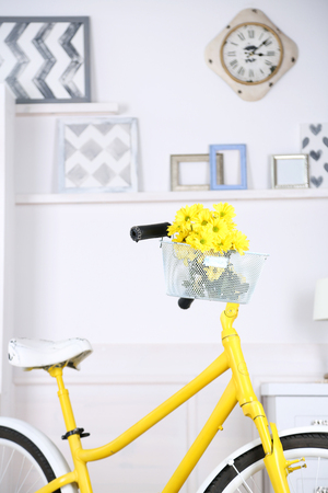 Yellow retro bicycle in spacious bright roomの写真素材