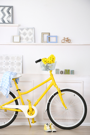 Yellow retro bicycle in spacious bright roomの写真素材