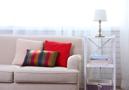 Room interior with comfortable sofa and colourful pillows, blurredの写真素材