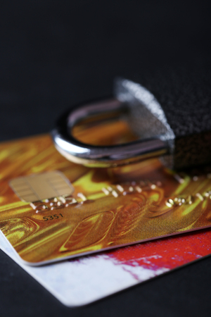 Concept of saving money - lock with credit cards on black backgroundの写真素材