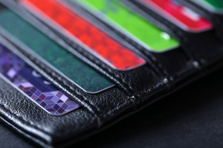 Black leather wallet with credit cards and money, close upの写真素材