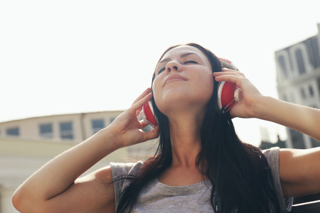 Attractive young woman listen music with headphonesの写真素材