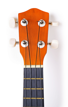 Close-up head and neck parts of the Hawaiian acoustic guitar isolated on whiteの写真素材
