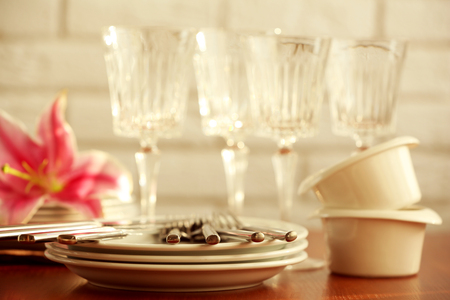 Clean dishes on table on brick wall backgroundの写真素材