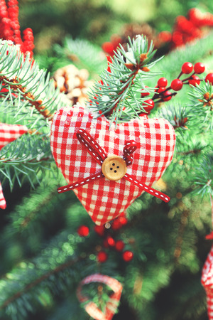 Christmas toys on fir tree branch, outdoorsの写真素材
