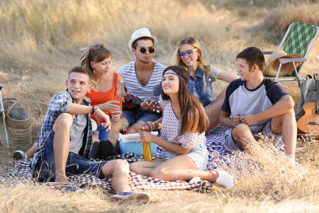 Happy friends have fun on picnic, outdoorsの写真素材