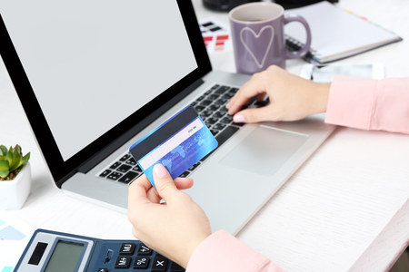 Concept for Internet shopping: hands with laptop and credit cardの写真素材
