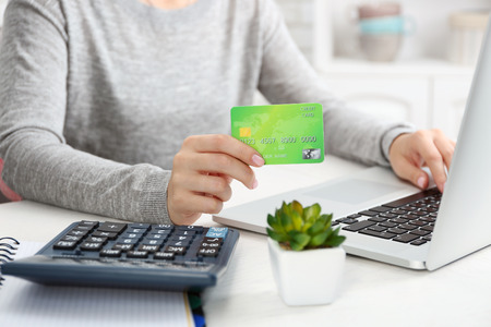 Concept for Internet shopping: hands with laptop and credit cardの写真素材