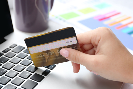 Concept for Internet shopping: hands with laptop and credit cardの写真素材