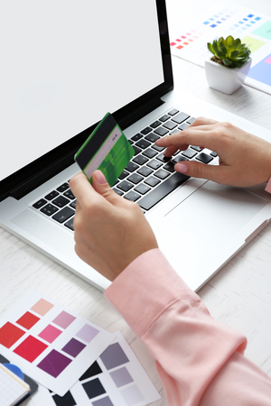 Concept for Internet shopping: hands with laptop and credit cardの写真素材