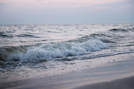 Sea wave on the shore at sunset