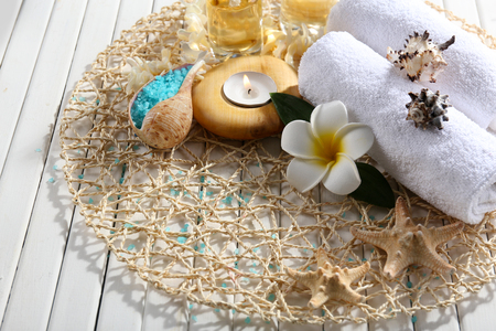 Decorated spa composition on wicker serviette, close upの写真素材