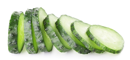 Sliced cucumbers isolated on whiteの写真素材