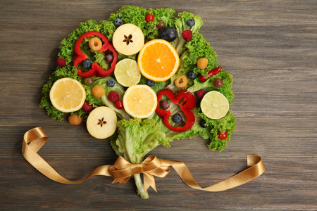 Beautiful bouquet of fruits and vegetables on wooden backgroundの写真素材