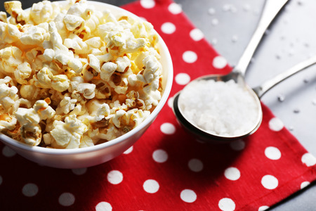 Salted popcorn in bowl on napkinの写真素材